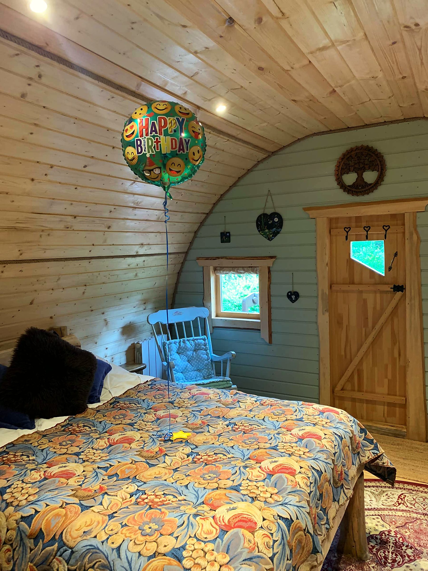 The double bed beneath the curved timber roof — view 8
